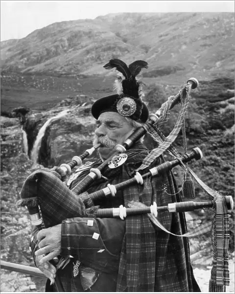 Bagpiper in Glen Coe, Highlands of Scotland