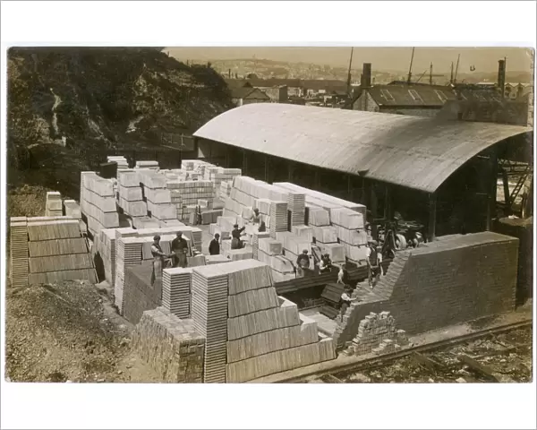 Men at work with paving stones and bricks near docks, UK