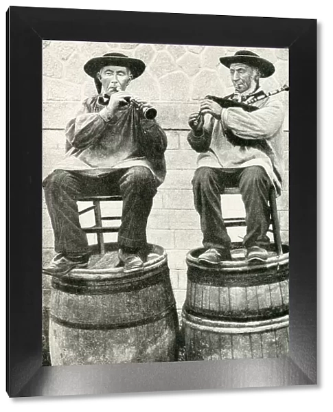 Musicians seated on barrels, Brittany, Northern France
