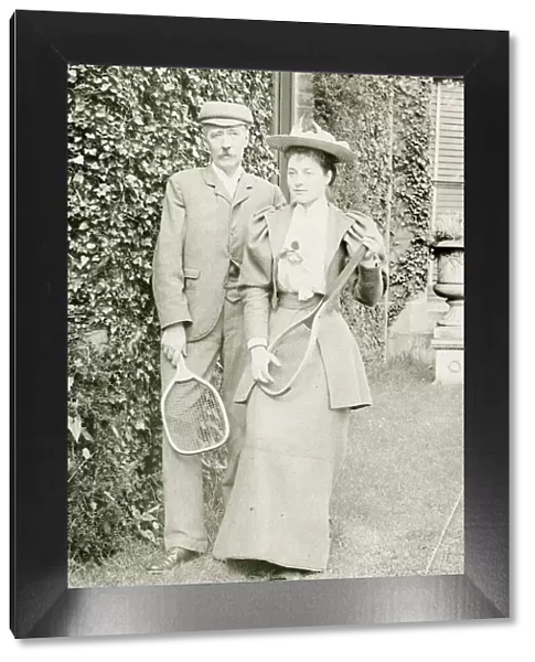 Couple posing with tennis rackets
