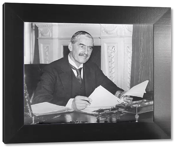 Neville Chamberlain, British Prime Minister, at his desk