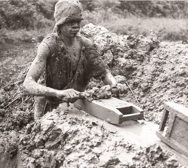 1940s East Africa - Uganda brick maker covered in mud