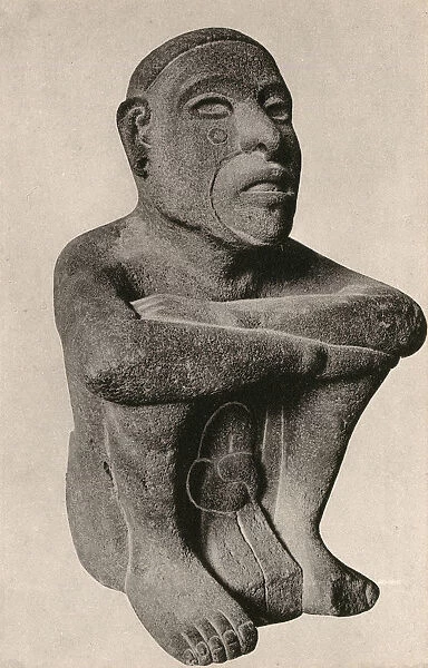 Aztec statue of a seated man - fire deity Huehueteotl