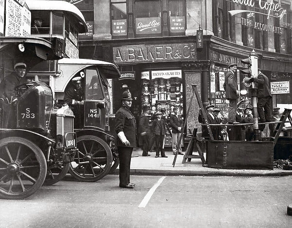 c. 1930s street scene in London with bus and policeman