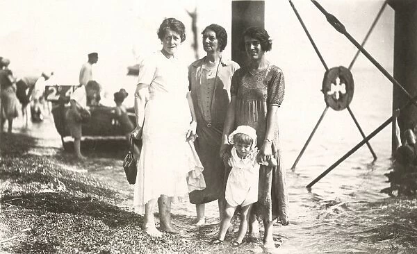 Candid seaside photograph - 3 women and child - under pier