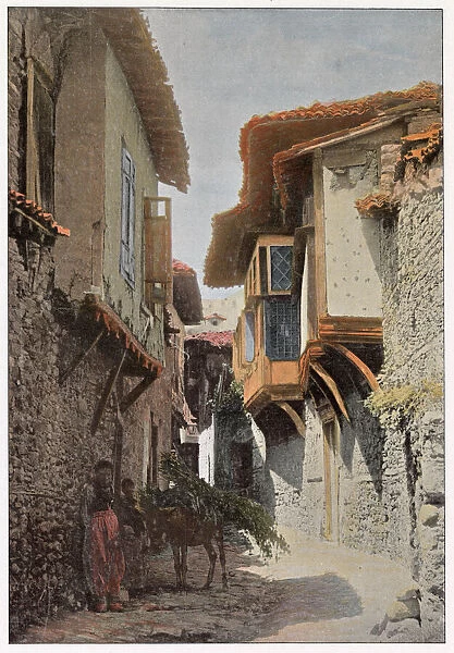 A characteristic narrow street in Aydin, western Turkey. Date: 1890s