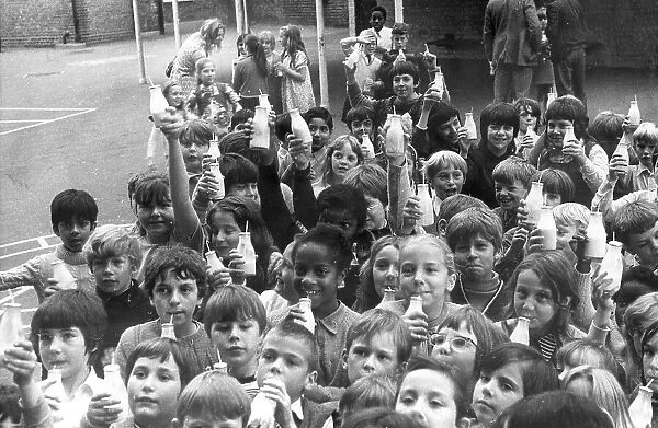Children drinking milk in a playground, Woolwich, London