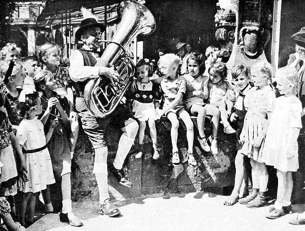 Children listening to a tuba player, Berlin, 1945