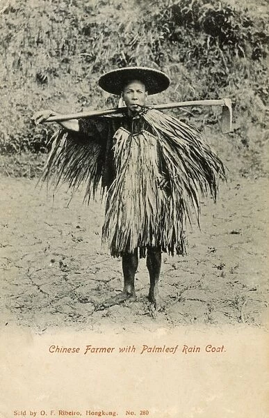 Chinese Farmer with Palmleaf Raincoat carrying hoe
