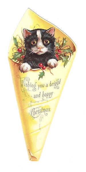 Christmas card in the shape of a kitten in wrapping paper
