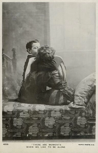 Couple kissing on a chaise longue