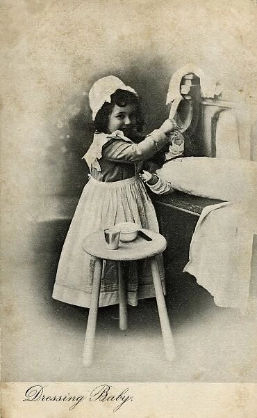 Dressing Baby -- little girl with her doll