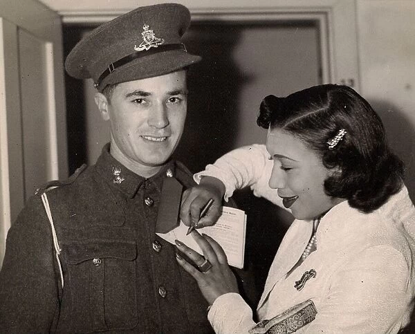 Elisabeth Welch signs an autograph for a serviceman at a con