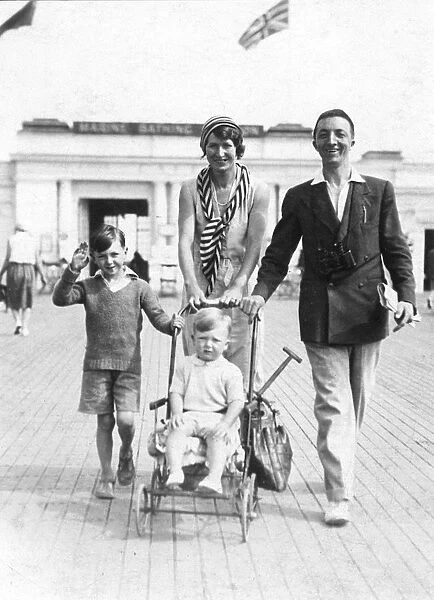 Family enjoying a holiday walk on a seaside promenade