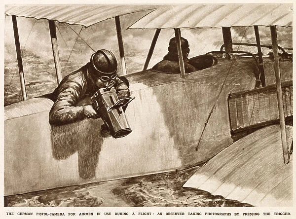 A German observer taking aerial photographs using a pistol-camera over the side of his