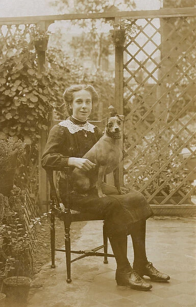Girl with a dog in a garden