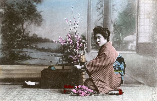 Japanese Geisha girl arranging flowers