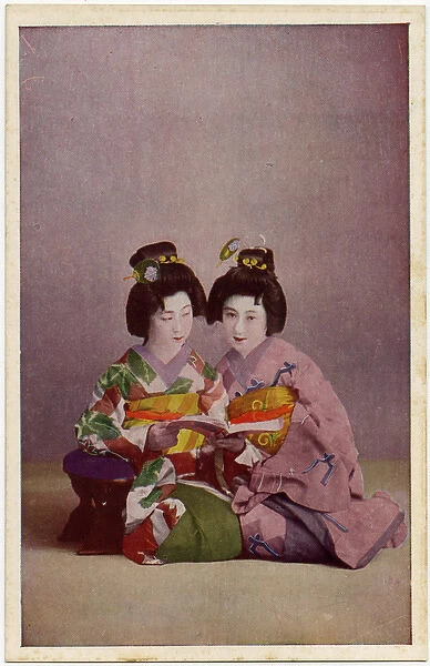 Two Japanese Geisha girls in colourful Kimonos