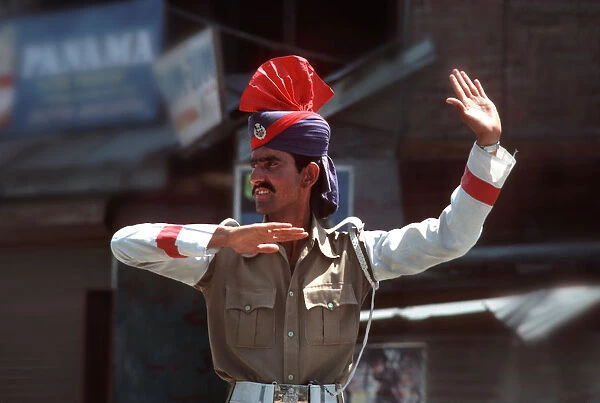 Kashmiri policeman on traffic duty in Srinagar, Kashmir