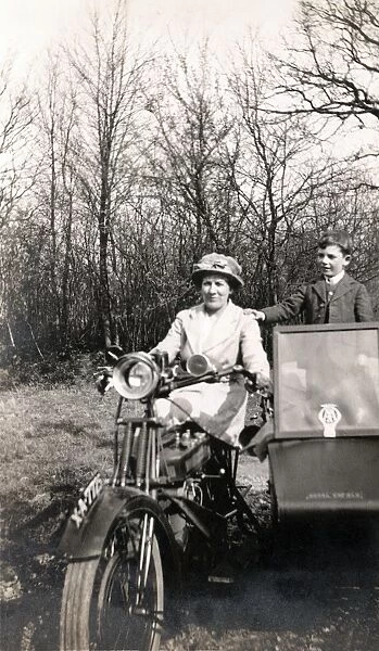 Lady on 1920 Royal Enfield motorcycle combination with boy