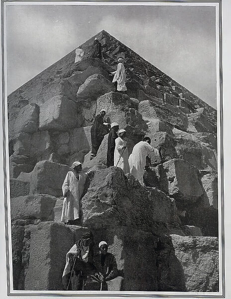 Men climbing pyramid in Egypt