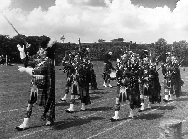 Men of the Oban Pipe Band, playing their bagpipes at the Highland Games, Tobermory