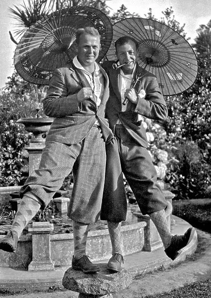 Two men in plus fours, holding parasols