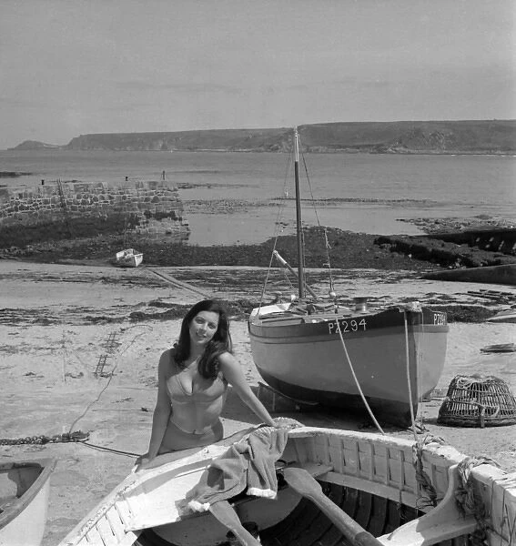 Model on a beach with fishing boats