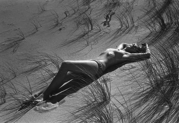 Model reclining in the sand dunes