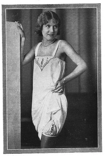 Model wearing embroidered chemise over embroidered long knickers and stockings Date: 1920s