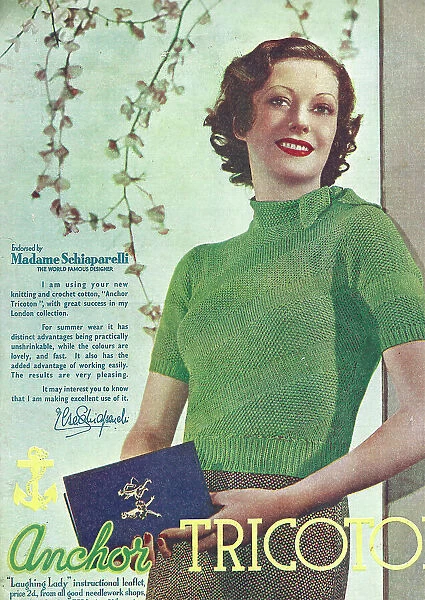 Model wearing tight crocheted cotton sweater in green with a tie collar, the cotton endorsed by couturier Mme Schiaparelli Date: 1935