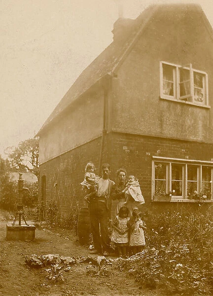 Mother, Father and children pose in their kitchen garden