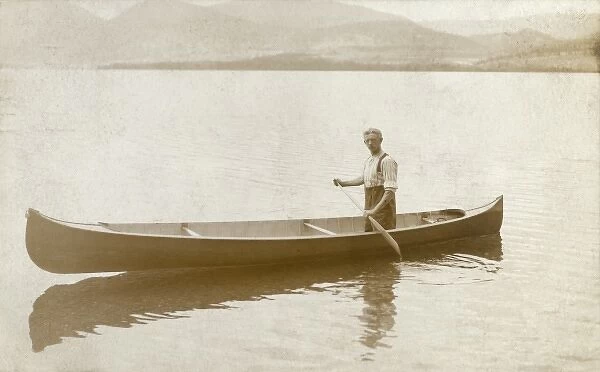 Newfoundland and Labrador - Man paddling a canoe