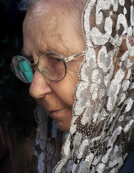 An old lady wearing a white lace mantilla shawl, Maderia