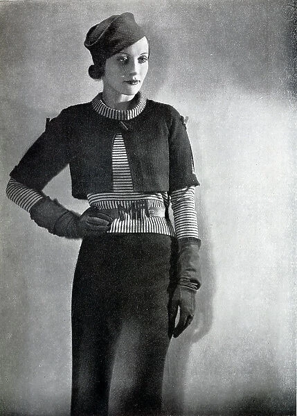 Outfit designed by Maggy Rouff, studio fashion portrait. Captioned, Short Coats for Longer Days'. With description, Spring suits are, like our spring climate, variable