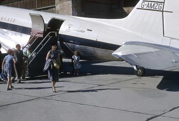 People disembark from a Transair aeroplane