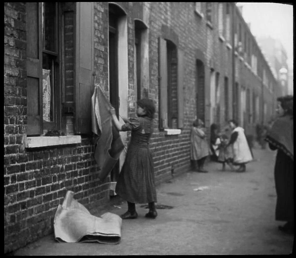 People on a street of terraced housing, London