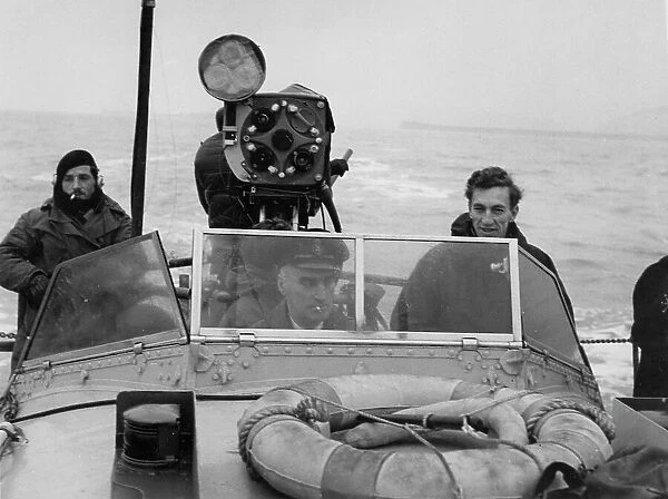 Raymond Baxter filming at sea, on location