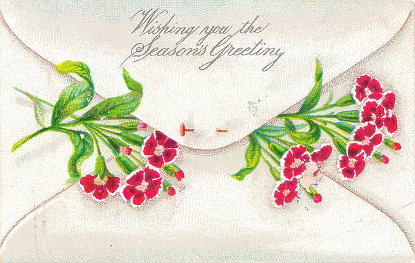 Red flowers in an envelope on a Christmas card