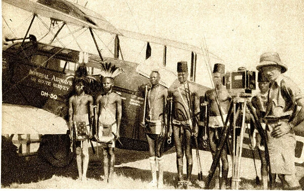 Shulluk warriors pose by Alan Cobhams aeroplane, Sudan