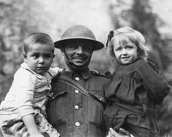Soldier with two refugee children, Tournai, Flanders, WW1