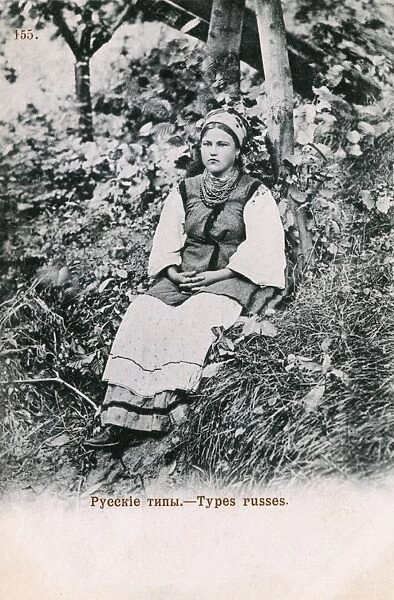 Sullen Russian girl seated in the undergrowth