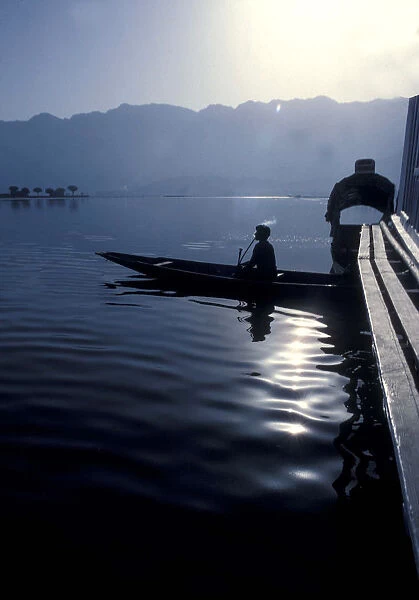 Tobacco smoking boatman silhouette, Dal Lake, Kashmir