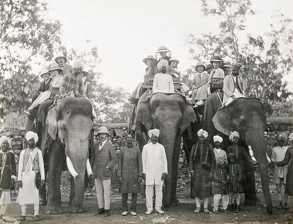 Travellers riding elephants in India, c. 1900
