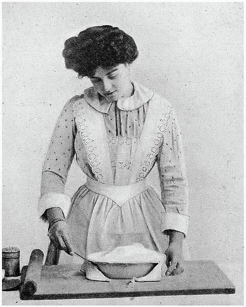 Trim the edge of the tart with share knife. Date: 1907