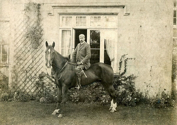 Victorian country gentleman on horse in front of house