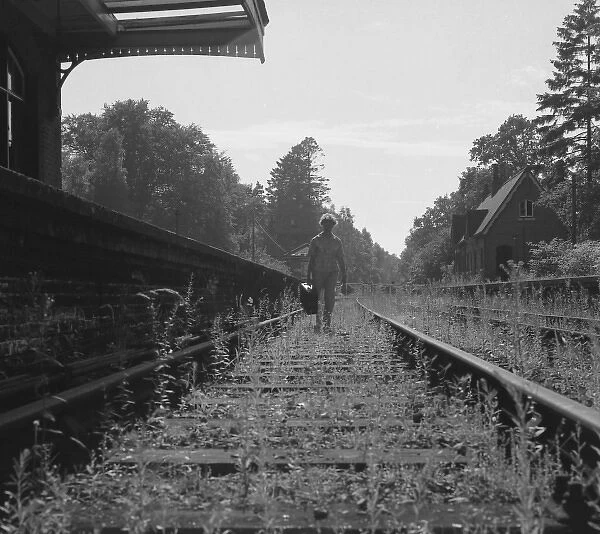Woman walking along a disused railway track