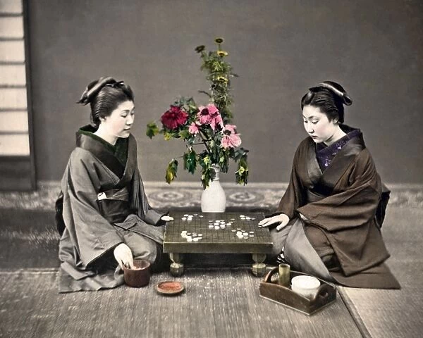 Two women playing board game, Japan