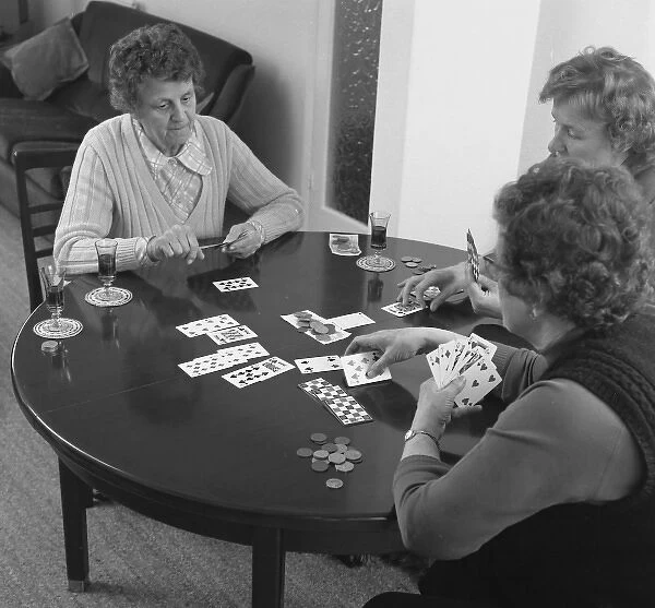 Three women playing cards at a table