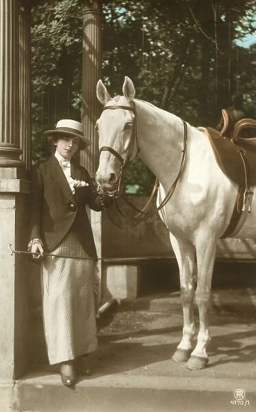 A young lady with her fine grey horse